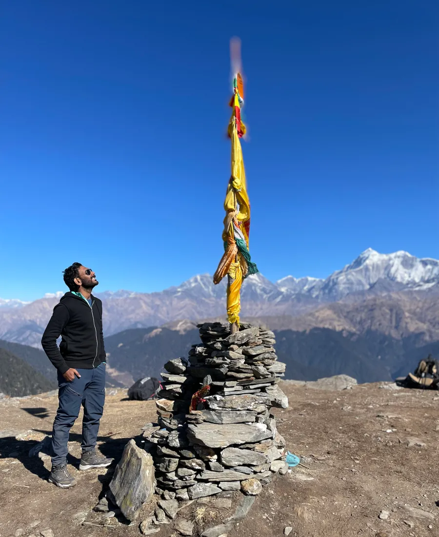 Banu at a Himalayan summit cairn